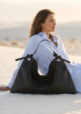 KYAGE black nappa leather hobo bag worn on shoulder lifestyle view