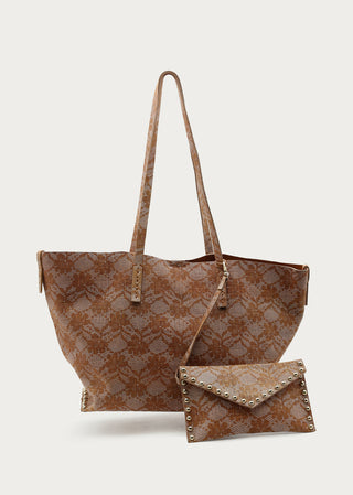 Camel leather shopper bag with matching studded pouch on a light neutral background.