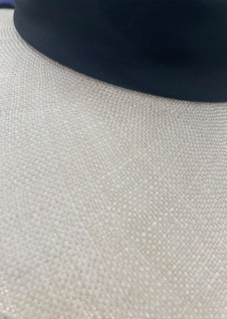 Close-up texture detail of the Lucia Hat showing the fine woven natural fiber construction