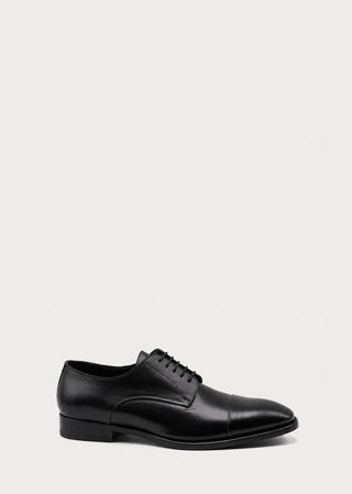 Black Italian leather lace-up shoe with classic cap-toe design on a neutral background.