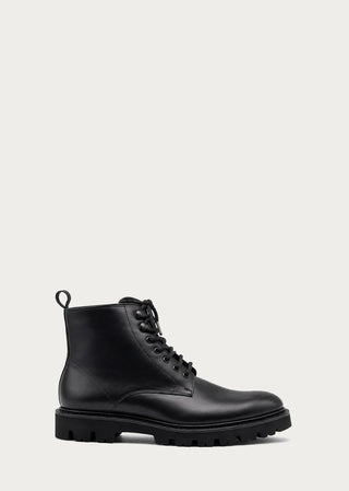 Single black leather lace-up boot with minimalist silhouette on a light neutral background.
