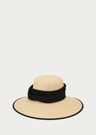 Handcrafted wide-brim hat in natural woven fibers with a black textile band by Copardo